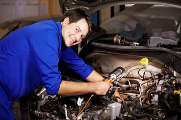 Image showing Portrait, smile and car with a mechanic man in a workshop as an engineer looking at the engine of a vehicle. Garage, service or repair with a happy technician working under the hood of an automobile