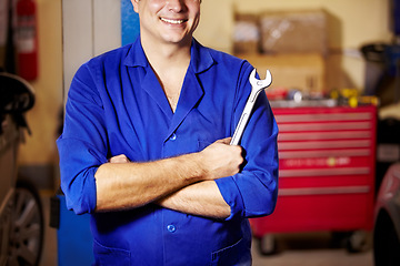 Image showing Happy man, arms crossed and hands of mechanic with spanner to repair, maintenance and auto service. Confident technician, wrench and tools to fix, inspection and professional at garage or workshop