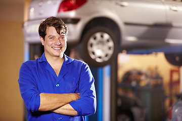 Image showing Happy, portrait and a mechanic with arms crossed in a workshop for pride in a car. Smile, working and a man in a garage for work, maintenance or building a vehicle for transportation or inspection