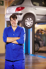 Image showing Portrait, happy man and mechanic with arms crossed at garage, service workshop or business. Confident, smile or professional technician, motor car repair expert or auto maintenance engineer in Canada