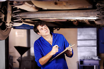 Image showing Car, inspection or service with a mechanic man in a garage for a report on a vehicle repair for insurance. Maintenance, professional and expertise with a young engineer in a workshop for assessment