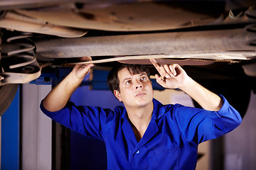 Image showing Car, inspection or service with an engineer man in a garage for a report on a vehicle repair for insurance. Maintenance, professional and expertise with a young mechanic in a workshop for assessment