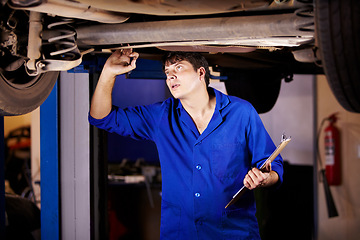 Image showing Car, inspection or maintenance with a mechanic man in a garage for a report on a vehicle repair for insurance. Service, professional and expertise with a young engineer in a workshop for assessment