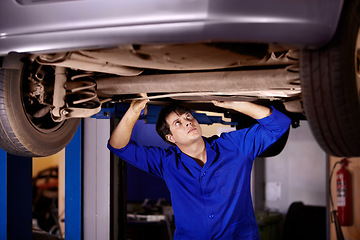 Image showing Car, inspection or repair with a mechanic man in a garage for a report on a vehicle service for insurance. Maintenance, professional and a young professional engineer in a workshop for assessment
