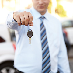 Image showing Businessman, hand and key to car outdoor with sale of auto, transportation and investment. Vehicle, dealership or man with keys in parking lot from salesman for test drive, opportunity or driving