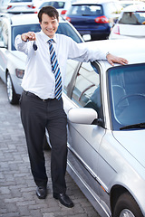 Image showing Businessman, portrait and key in hand to car with sale of auto, transportation and investment. Vehicle, dealership or man with keys in parking lot from salesman for test drive, opportunity or driving