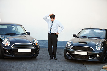 Image showing Business man, thinking and choice of car at dealership, shop and store. Confused, customer and decision for motor vehicle sales, doubt to buy convertible and shopping for auto transportation outdoor