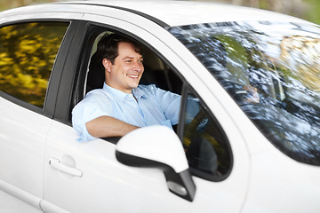 Image showing Smile, road trip and a man driving a car outdoor for travel, freedom or adventure in an autumn forest. Journey, ride or commute with a happy young person in a vehicle form transport as a driver