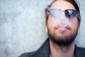 Image showing Face, man and smoking outdoor with sunglasses for addiction, experience and enjoyment on mock up space. Person, hipster and smoke on mockup for lifestyle, luxury and exhale or tobacco satisfaction