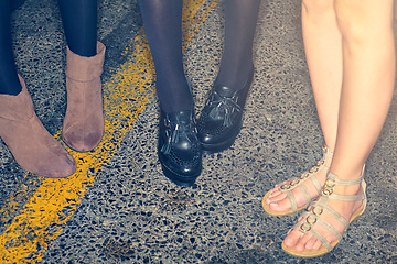 Image showing Closeup, women or feet with shoes for fashion, vintage style or aesthetic in road for lifestyle or trend. Person, legs and flats or boots for creativity, retro or unique footwear on street background