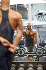 Image showing Man, arm flexing and mirror at gym with fitness, workout and exercise of bodybuilder with reflection. Muscle, male person and athlete with sport training, wellness and body builder at a health club