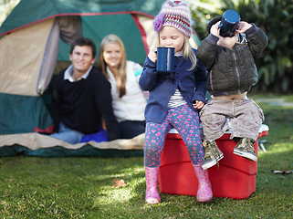 Image showing Morning, coffee and family in nature for camping, relax and children bonding with a drink. Happy, parents and siblings or kids with tea or cacao while at a park for a holiday, vacation or camp