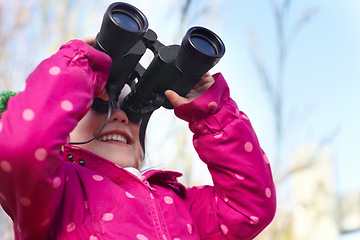 Image showing Binoculars, nature and child for explore, discovery and looking on adventure outdoors. Travel, winter and happy, young and excited girl search on holiday, vacation and freedom on weekend for camping