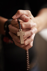 Image showing Hands, prayer with beads and worship for religion, trust and spiritual wellness with hope, peace and love. Support, mindfulness and person in Christian faith praying, gratitude and rosary with cross.