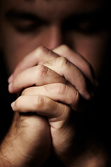 Image showing Praying, hands and man for faith, hope and religion or asking for help with mental health, depression or worship in dark room. Sad Christian person with peace, spiritual guidance and God for support