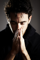 Image showing Hands, pray and man praise God with gratitude and respect for religion on grey background. Guide, wellness and prayer, worship and faith, hope and trust with belief and healing from grief in a studio