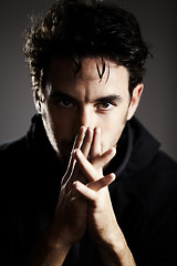Image showing Dark, mystery and portrait of a man on a black background for agent, detective or spy work. Young, looking and a person with the mafia on a backdrop for a target, fear or staring on a backdrop