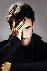 Image showing Sad, portrait and a man with depression on a studio background for mental health or mindset. Stress, frustrated and a person with anxiety, fail or a mistake with a disaster or crisis on a backdrop