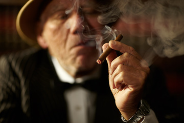 Image showing Old man, smoking and cigarette in hand with smoke and crime boss of mob with a decision. Gangster, face and senior person with vintage cigar in mafia or country club with luxury, vice or habit