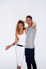 Image showing Fashion, middle finger and portrait of couple on a white background with trendy clothes, style and outfit. Angry, upset and isolated man and woman in studio with confidence, attitude and emoji