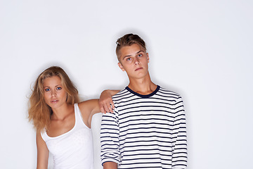 Image showing Fashion, confident and portrait of couple on a white background with trendy clothes, style and cool outfit. Beauty, aesthetic and isolated man and woman in studio with serious face, attitude or pride