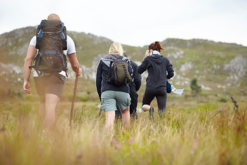 Image showing Nature, backpack and group of friends on hiking adventure in mountain with freedom from back. Travel, trekking and people walking in countryside, men and women on natural outdoor journey together.