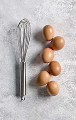 Image showing brown eggs and whisk