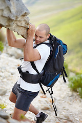 Image showing Man with backpack, rock climbing and hiking adventure in mountain with nature, freedom and power. Travel, trekking and hanging, strong person in countryside on natural outdoor journey with fitness.