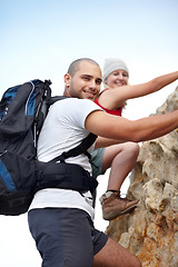 Image showing Couple in portrait, rock climbing and hiking adventure in mountain with nature, freedom or power. Travel, trekking and hanging, man and woman on cliff for natural outdoor journey together in fitness.