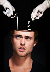 Image showing Hands pour medicine in head of man, mental health and treatment in studio isolated on a black background. Pills, sick person and antidepressant drugs or medication for depression, anxiety and stress