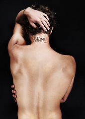 Image showing Back, shame tattoo and nude man in studio isolated on a black background. Rear view, regret and body of person embarrassed at mistake, fail and abuse crisis, depression and mental health challenge