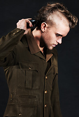 Image showing Military, soldier and man shaving hair in studio isolated on black background. Army, serious and person shave head with clipper machine in profile for haircut to prepare for service, bootcamp or war