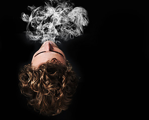 Image showing Man smoking marijuana, drugs or cigarette in studio isolated on black background mockup. Smoke, vape and person exhale cannabis, weed and addiction to tobacco, 420 cbd or substance abuse in top view