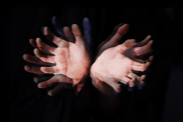 Image showing Blur, ghost hands on black background and closeup in studio isolated on an abstract dark backdrop. Palm, fingers and demon, fantasy and surreal horror, fear danger and scary nightmare on Halloween