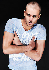 Image showing Portrait, fashion and man in tshirt with arms crossed in studio isolated on a black background. Face, serious and confidence of person with casual clothes, cool style and trendy model in Australia