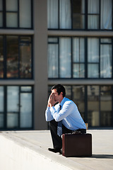 Image showing Businessman, suicide and roof with stress, depression and mental health with suitcase outdoor in city. Professional, person or employee and rooftop of building with anxiety, risk, crisis and unhappy