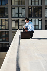 Image showing Businessman, suicide or roof and thinking, depression and mental health with suitcase outdoor in city. Professional, person or employee and stress on rooftop of building with anxiety, risk and crisis