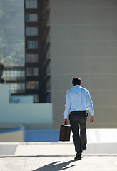 Image showing Businessman, suicide and edge with stress, depression or problem on rooftop of building with suitcase for risk. Professional, person or employee with briefcase, mental health and anxiety in city