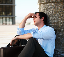 Image showing Businessman, headache or outdoor with stress, depression and anxiety on roof of building for crisis. Professional, person or employee with suitcase, mental health or migraine for problem or suffering