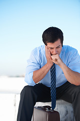 Image showing Businessman, headache or stress from depression or anxiety on rooftop of building with suitcase for risk or problem. Professional, person or employee with briefcase or worry on roof for mental health