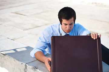 Image showing Suitcase, rooftop and businessman on a building in the city searching or looking for work bag. Corporate career, balcony and professional male lawyer with briefcase for legal documents in urban town.