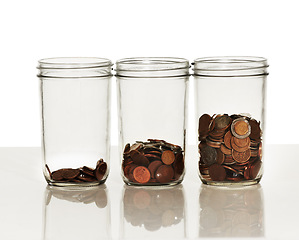 Image showing Money, jar and coins on a white background for finance, investment and financial growth. Accounting, economy and container with cash for savings, profit and wealth for budget, donation and payment