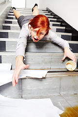 Image showing Woman, falling down and stairs for injury, accident and wow with coffee, documents or paperwork in building. Business, person or employee slipping on steps at work or office with paper, cup and shock