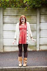 Image showing Rain, winter and wet woman on the sidewalk from water, puddle or accident in the city. Depressed, insurance and a young girl with a fail while raining in the road or street with a disaster or crisis