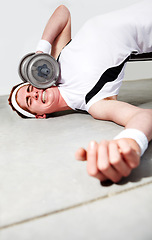 Image showing Fitness, face and dumbbell with an unlucky man in the gym after an accident while lifting heavy weights. Exercise, injury or pain with a young person making a mistake during a training workout