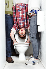 Image showing Geek, bully and students in a school toilet for abuse, fear or hazing of a victim in a bathroom stall. Portrait, dunk and upside down with a teen nerd embarrassed by thugs at university or college