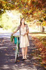 Image showing Bicycle, woman and nature for fitness in cycling, summer vacation and eco friendly park with wellness and exercise. Norway, person and trendy fashion in garden, sustainability and happy in cityscape