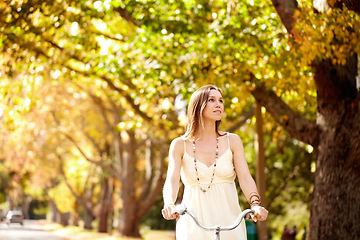 Image showing Woman, thinking and cycling for fitness in nature, vacation exercise and eco friendly central park for wellness. New york city, person or trendy fashion with bicycle, sustainability and urban travel