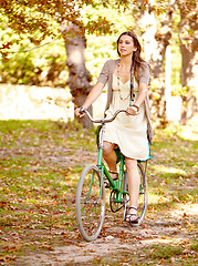 Image showing Bicycle, woman and nature for wellness in cycling, vacation and eco friendly park for health and exercise. New york, person and trendy fashion for summer, sustainability and thinking by trees