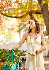 Image showing Woman, relax and walk with bicycle for fitness, nature vacation and exercise in eco friendly central park. New york city, person and trendy fashion for wellness, sustainability or urban summer travel